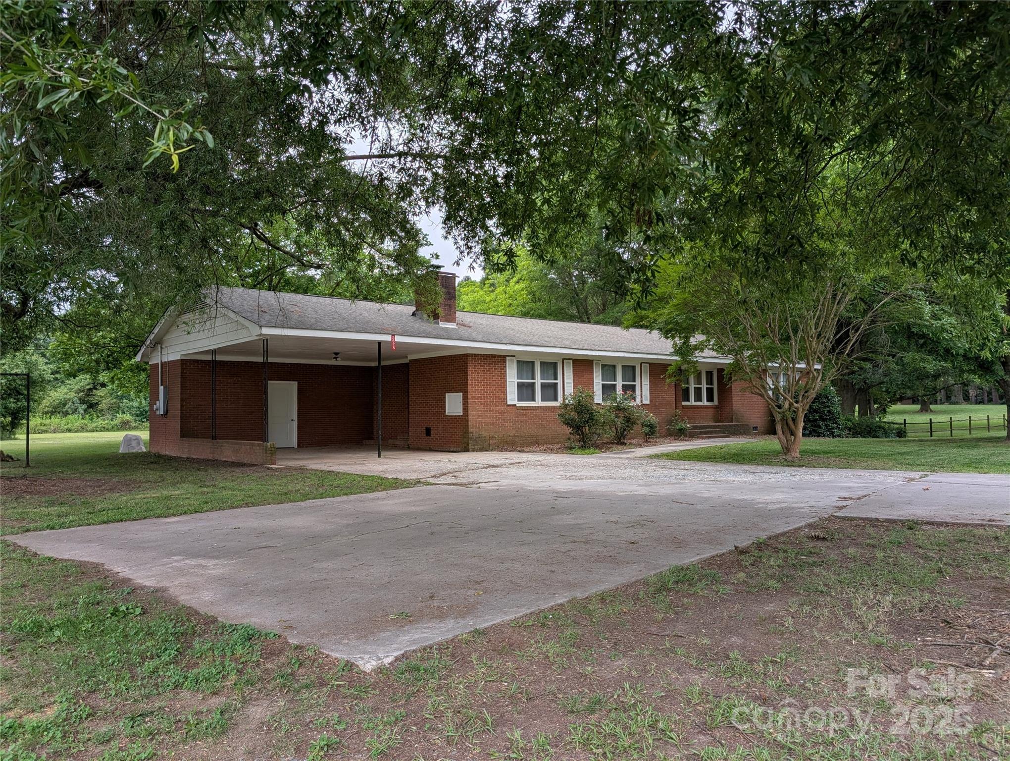 5628 White Store Road Wingate, NC 28174 - Photo 7 of 31 a front view of a house with a garden