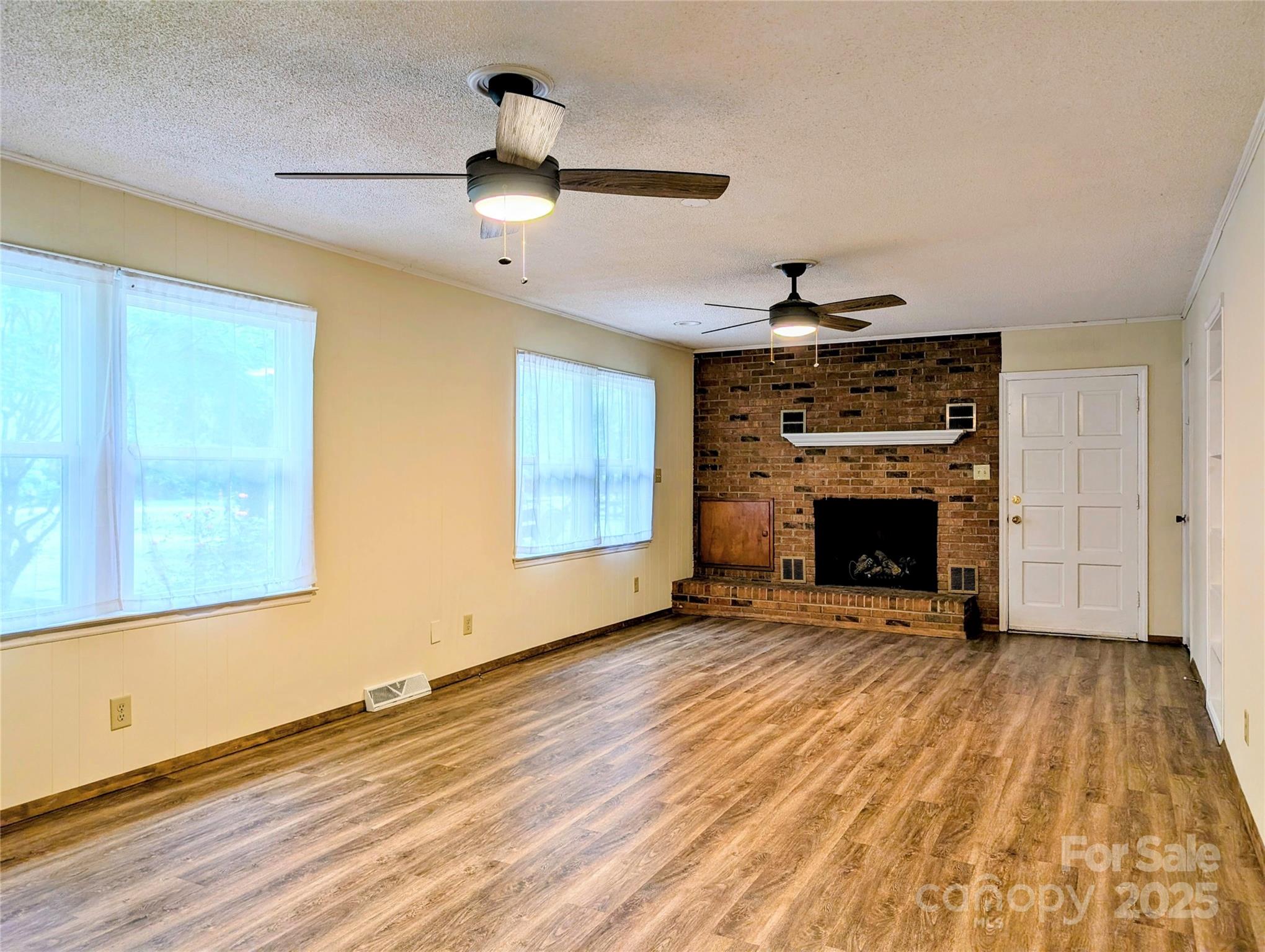 5628 White Store Road Wingate, NC 28174 - Photo 10 of 31 an empty room with windows fireplace and a sink
