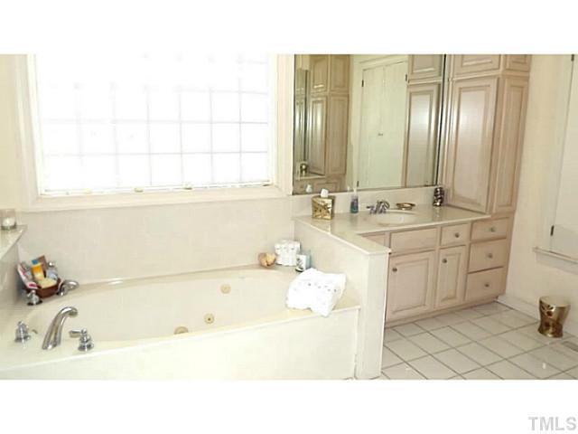 6671 Old Fairground Road Benson, NC 27504 - Photo 19 of 25 a bathroom with a sink tub double vanity and shower
