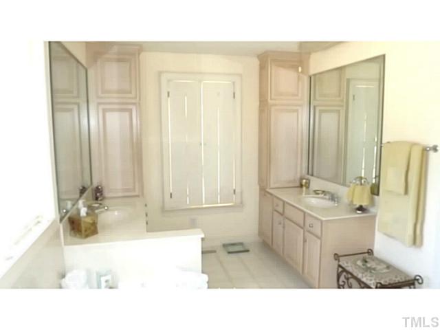 6671 Old Fairground Road Benson, NC 27504 - Photo 20 of 25 a bathroom with a tub sink and mirror