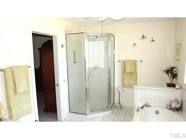 6671 Old Fairground Road Benson, NC 27504 - Photo 21 of 25 a bathroom with a tub and a shower