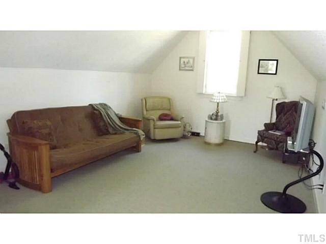 6671 Old Fairground Road Benson, NC 27504 - Photo 22 of 25 a living room with furniture and a chair