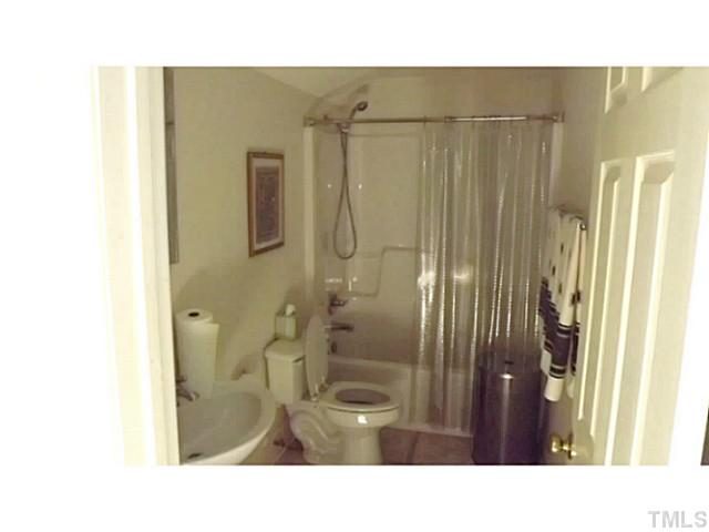 6671 Old Fairground Road Benson, NC 27504 - Photo 24 of 25 a bathroom with a sink a toilet and shower