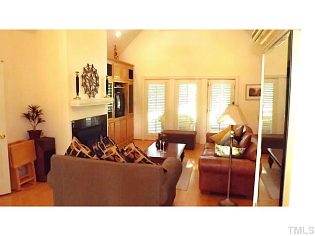 6671 Old Fairground Road Benson, NC 27504 - Photo 7 of 25 a living room with furniture a flat screen tv and a fireplace