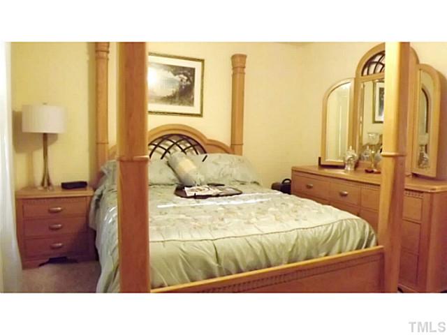 6671 Old Fairground Road Benson, NC 27504 - Photo 9 of 25 a bedroom with a bed and wooden floor