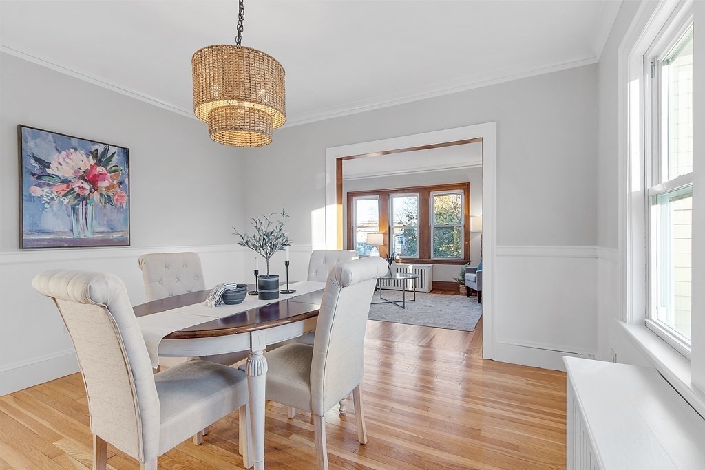 10 Victoria Road, Unit 2 Arlington, MA 02474 - Photo 11 of 28 a view of a dining room with furniture wooden floor and a chandelier