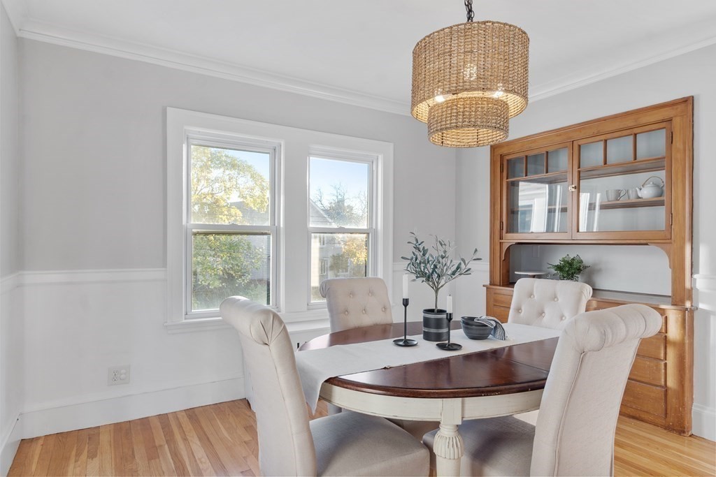 10 Victoria Road, Unit 2 Arlington, MA 02474 - Photo 12 of 28 a dining room with furniture a chandelier and wooden floor