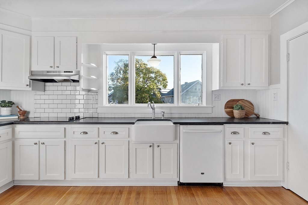 10 Victoria Road, Unit 2 Arlington, MA 02474 - Photo 17 of 28 a kitchen with white cabinets white appliances and a sink