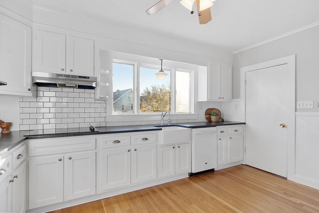 10 Victoria Road, Unit 2 Arlington, MA 02474 - Photo 18 of 28 a kitchen with granite countertop white cabinets white appliances and a sink