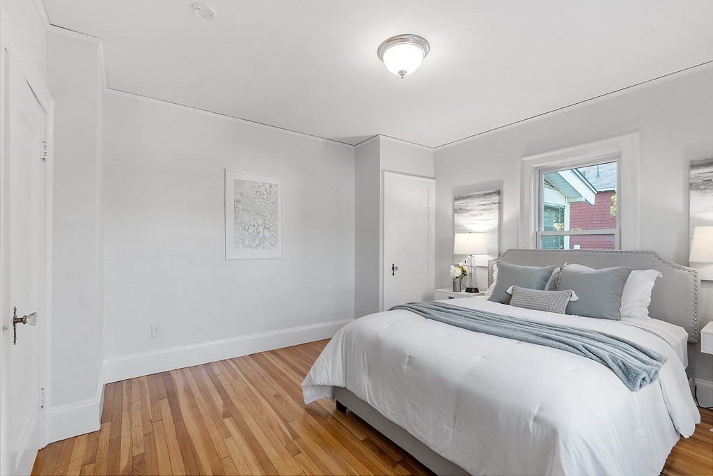 10 Victoria Road, Unit 2 Arlington, MA 02474 - Photo 20 of 28 a bedroom with a bed and wooden floor