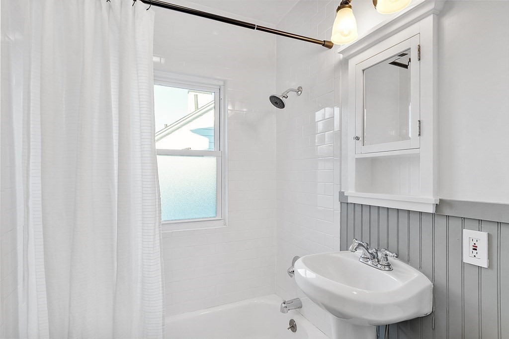 10 Victoria Road, Unit 2 Arlington, MA 02474 - Photo 21 of 28 a bathroom with a sink a window and shower