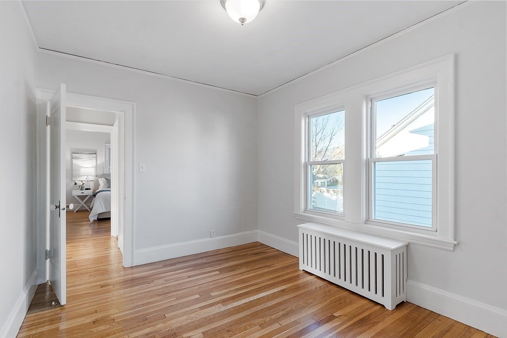 10 Victoria Road, Unit 2 Arlington, MA 02474 - Photo 22 of 28 wooden floor in an empty room with a window