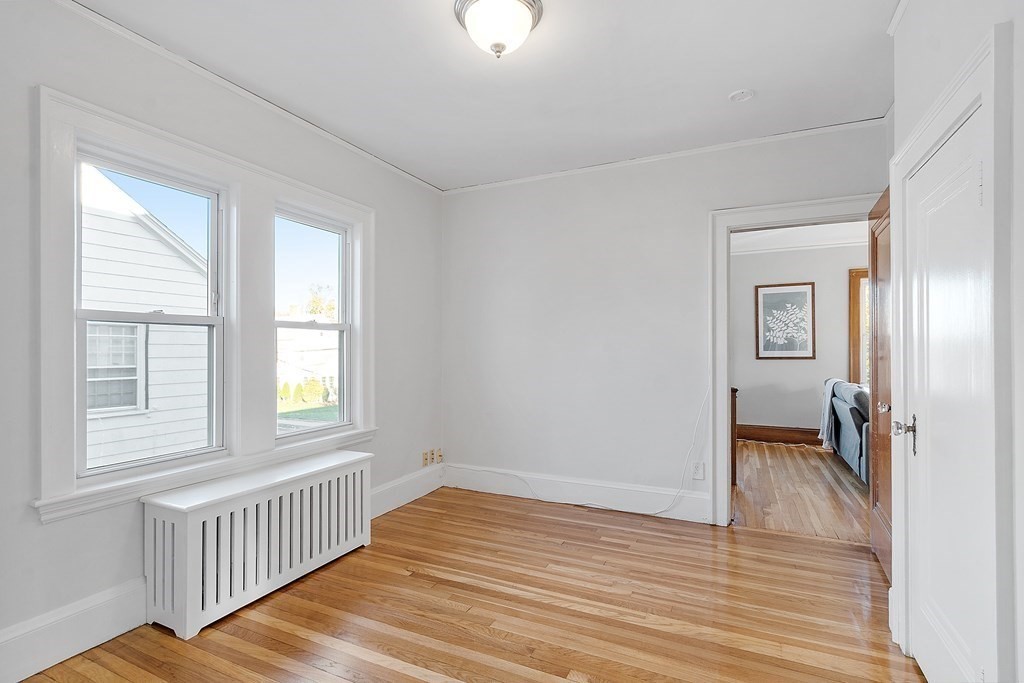 10 Victoria Road, Unit 2 Arlington, MA 02474 - Photo 23 of 28 wooden floor in an empty room with a window