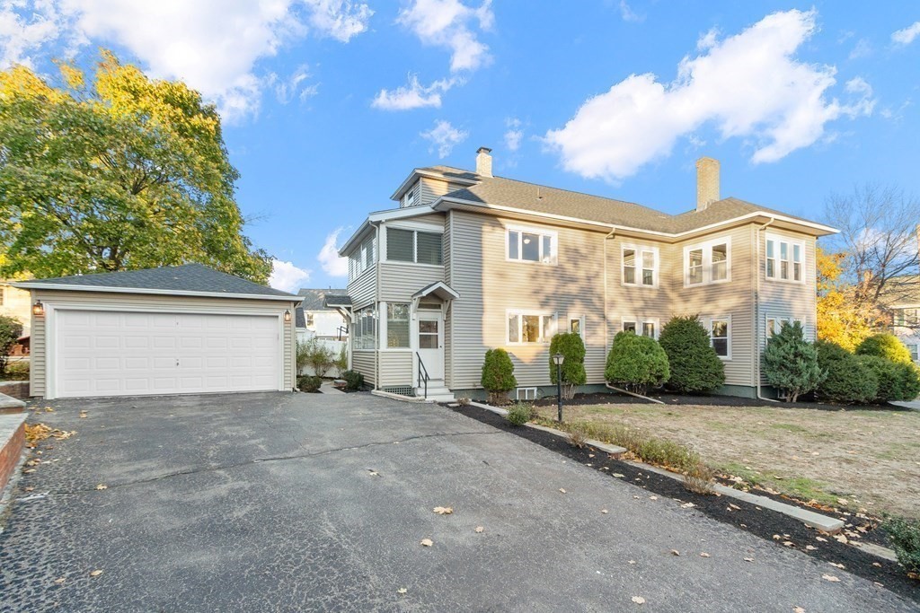 10 Victoria Road, Unit 2 Arlington, MA 02474 - Photo 28 of 28 a view of a house with a yard and potted plants