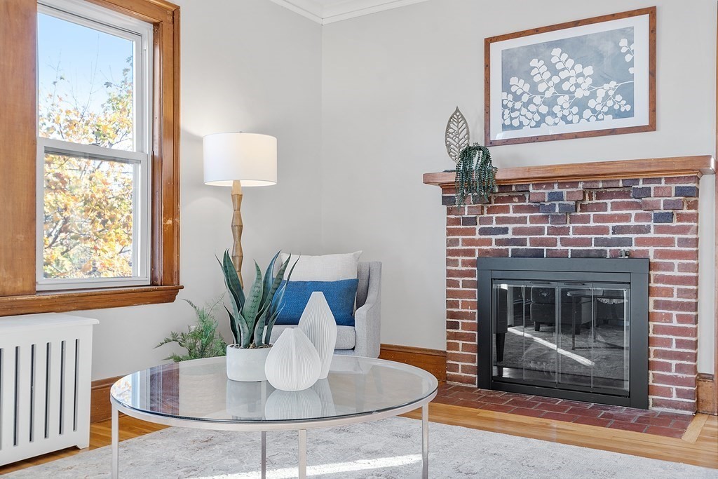 10 Victoria Road, Unit 2 Arlington, MA 02474 - Photo 5 of 28 a living room with furniture a table and a fireplace