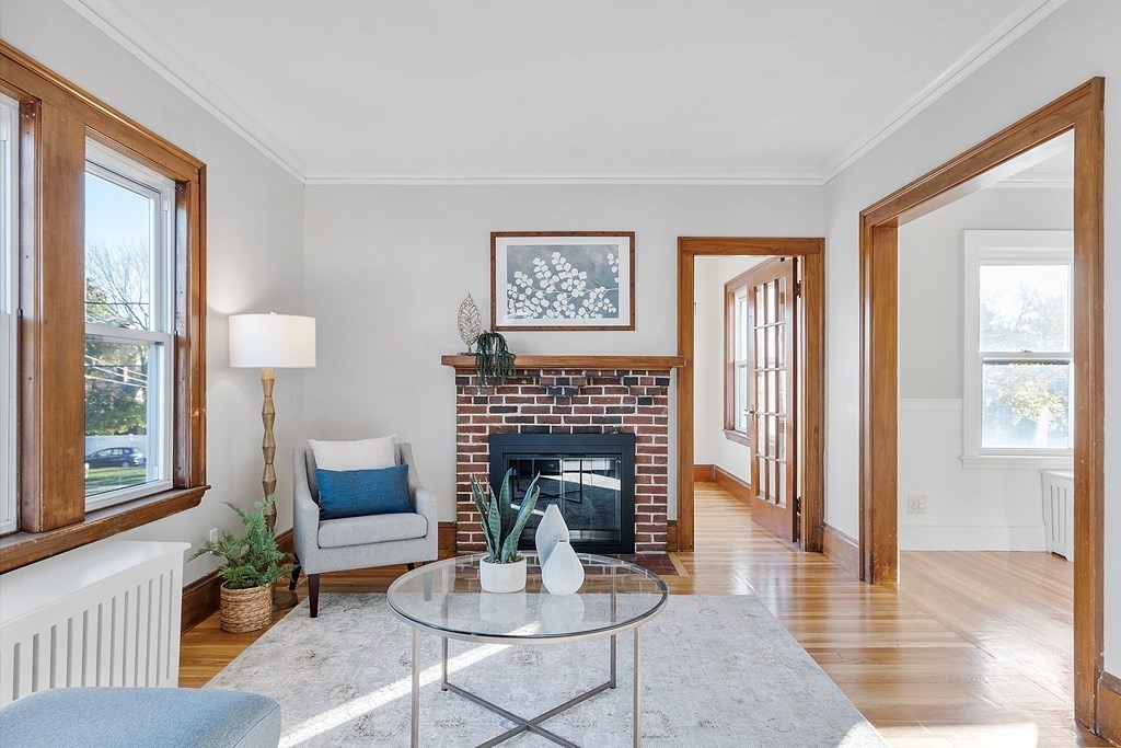 10 Victoria Road, Unit 2 Arlington, MA 02474 - Photo 6 of 28 a living room with furniture and a fireplace