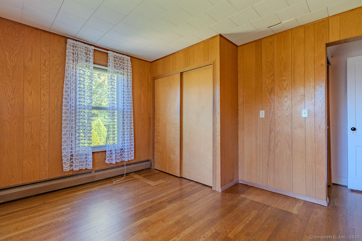 1152 Worthington Ridge Berlin, CT 06037 - Photo 11 of 40 a view of an empty room with wooden floor and a window