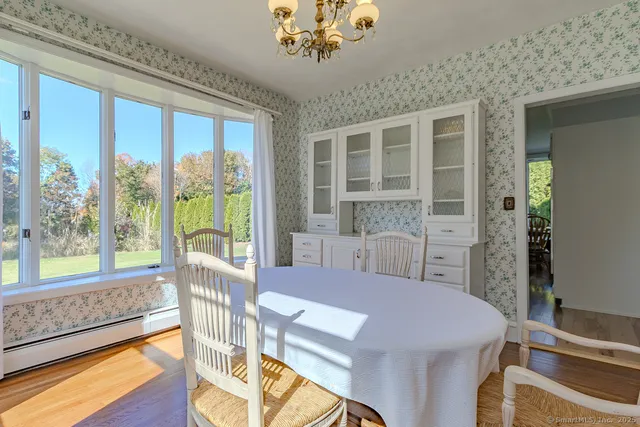 a view of a dining room with furniture and wooden floor