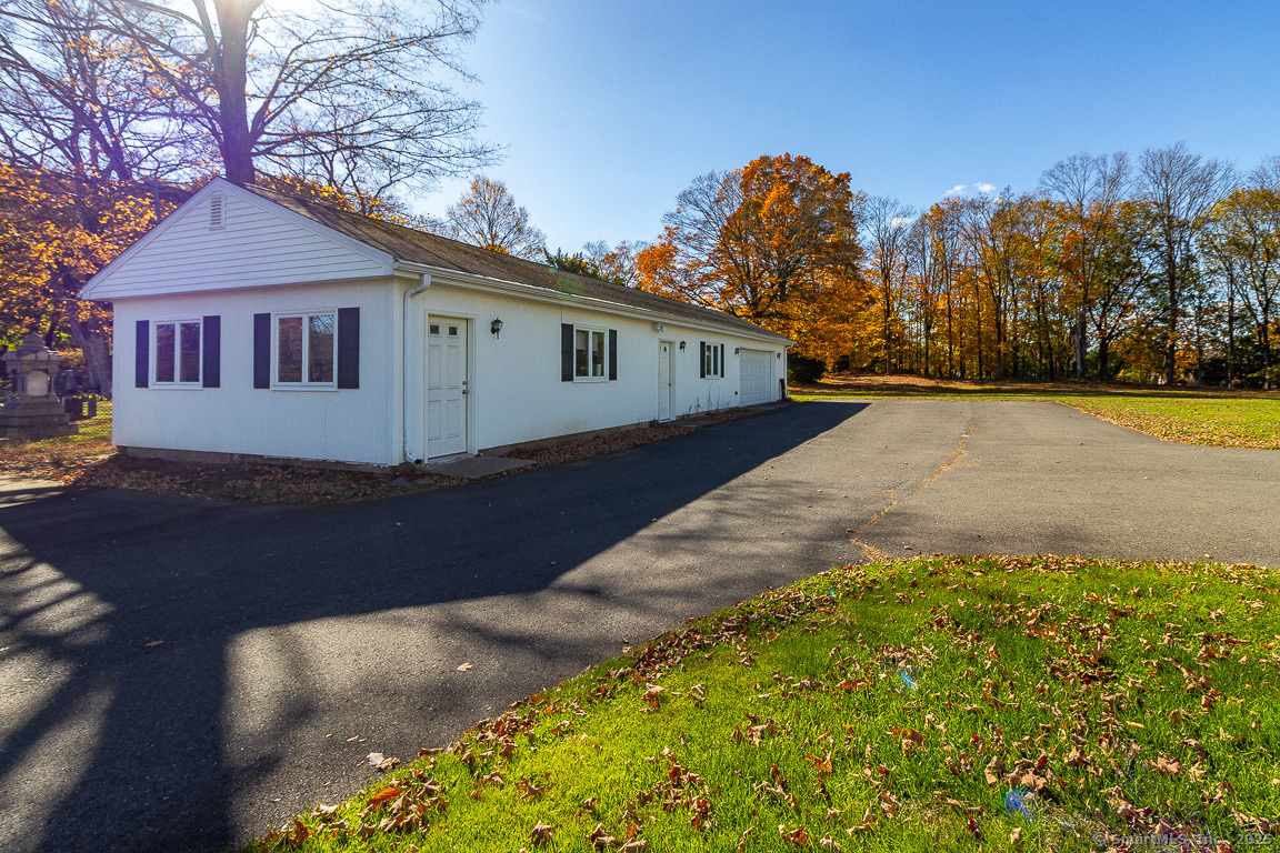 1152 Worthington Ridge Berlin, CT 06037 - Photo 16 of 40 a front view of a house with a yard and trees