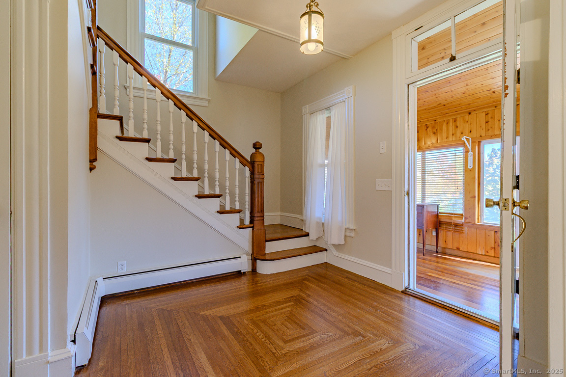 1152 Worthington Ridge Berlin, CT 06037 - Photo 2 of 40 a view of a hallway with wooden floor and staircase