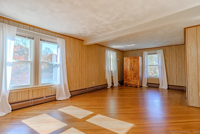 a view of an empty room with wooden floor