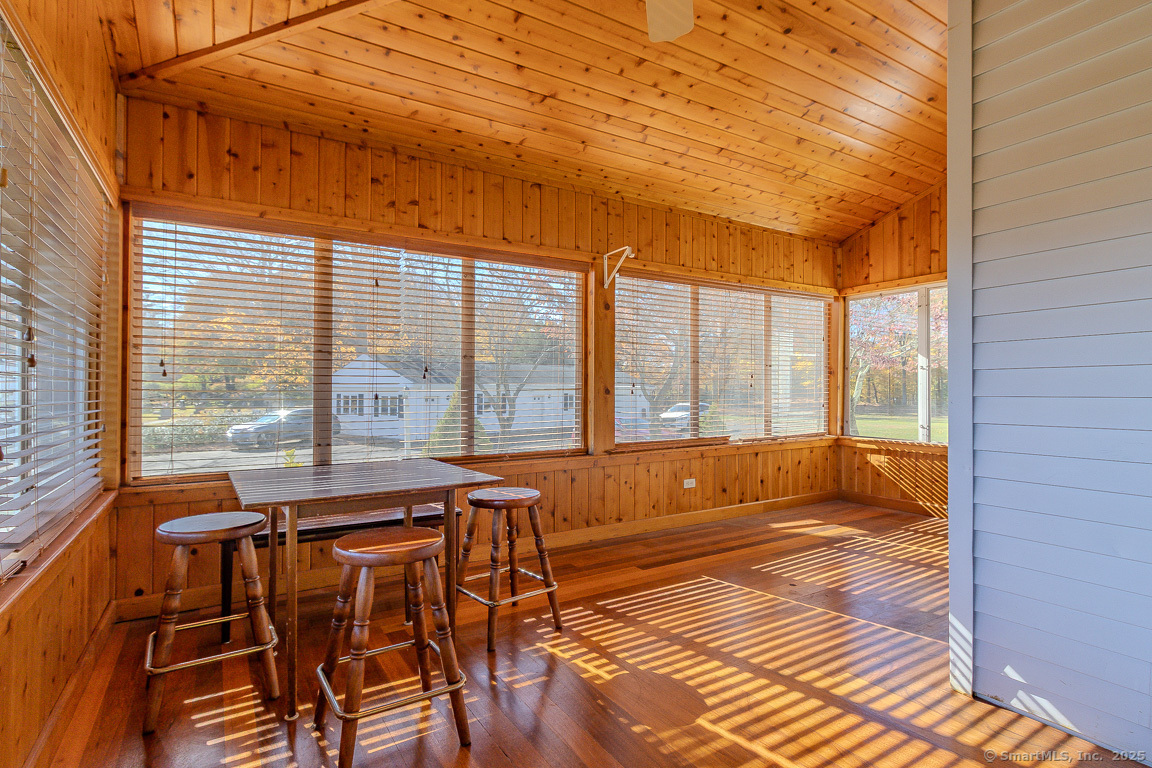 1152 Worthington Ridge Berlin, CT 06037 - Photo 27 of 40 a view of a patio with a table and chairs next to a window with wooden floor