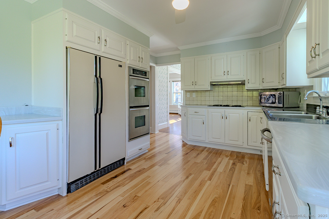 1152 Worthington Ridge Berlin, CT 06037 - Photo 3 of 40 a kitchen with stainless steel appliances a refrigerator and a stove top oven