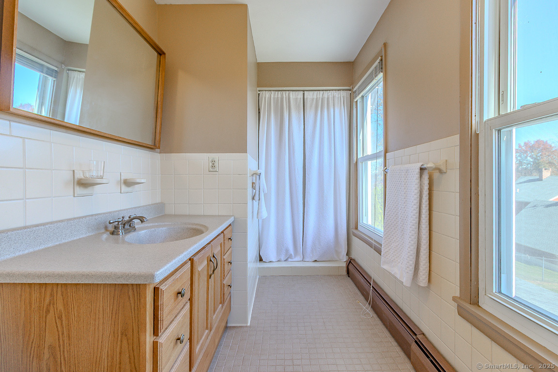 1152 Worthington Ridge Berlin, CT 06037 - Photo 31 of 40 a bathroom with a double vanity sink and a mirror