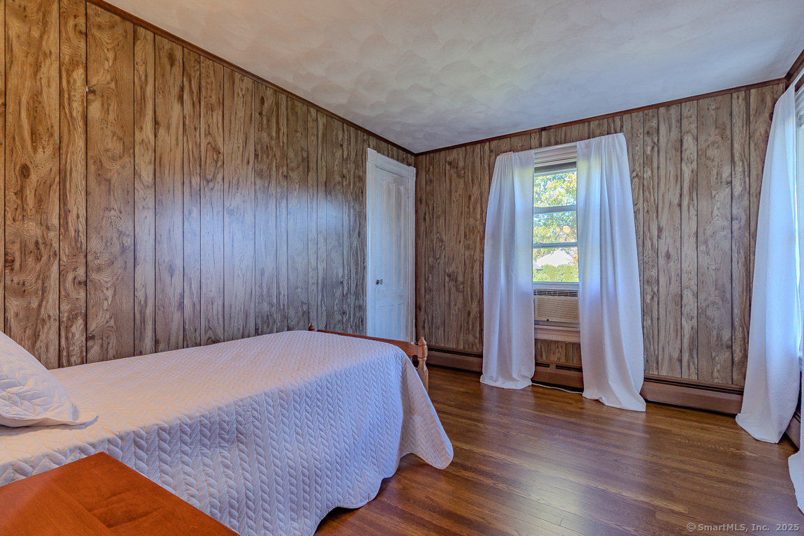 1152 Worthington Ridge Berlin, CT 06037 - Photo 37 of 40 a bedroom with a bed and wooden floor
