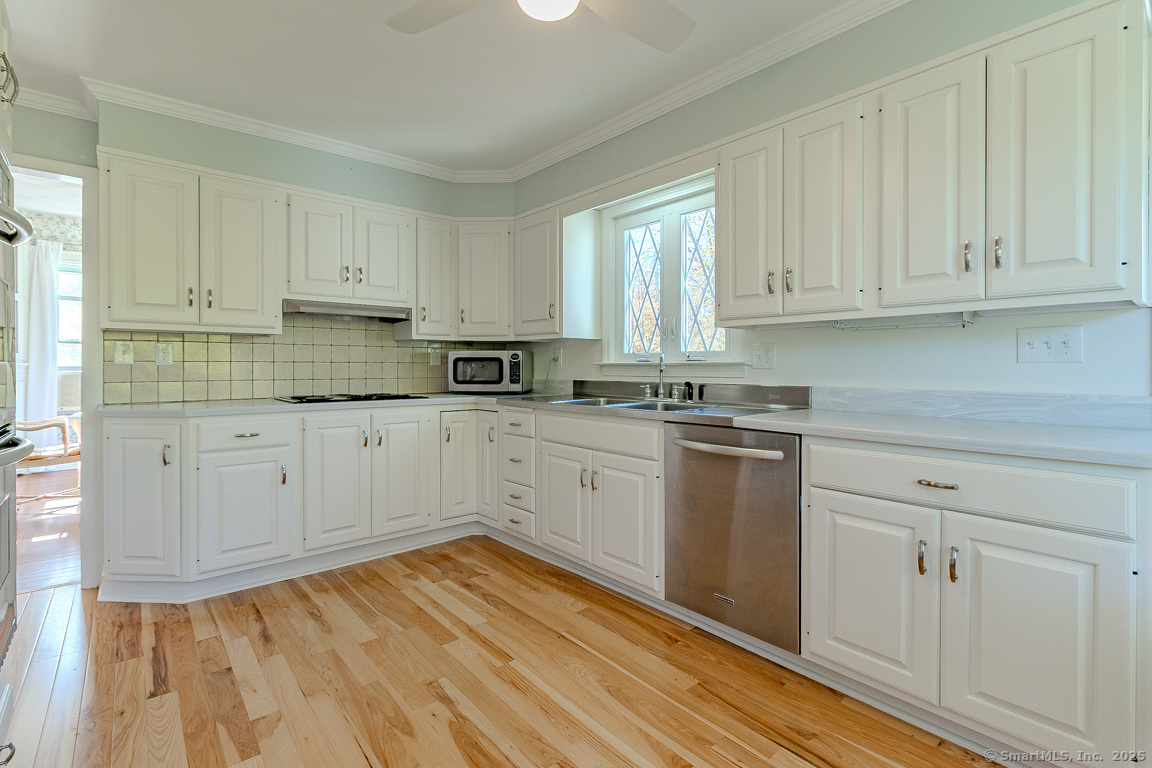 1152 Worthington Ridge Berlin, CT 06037 - Photo 5 of 40 a kitchen with granite countertop white cabinets and white appliances