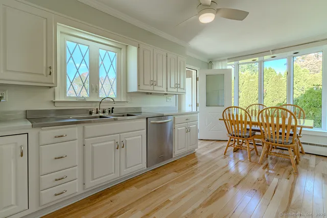 a kitchen with granite countertop white cabinets and white appliances