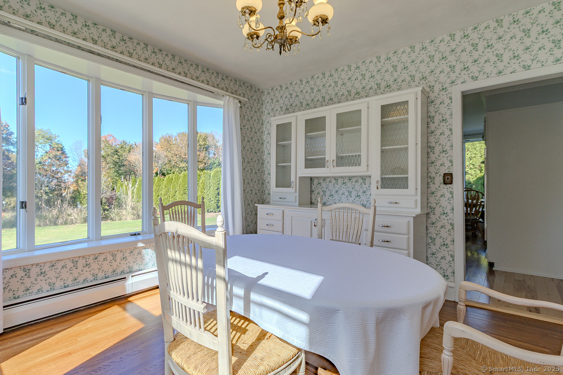 1152 Worthington Ridge Berlin, CT 06037 - Photo 8 of 40 a view of a dining room with furniture a chandelier and wooden floor