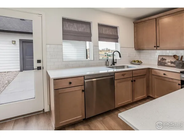 a kitchen with a sink cabinets and window