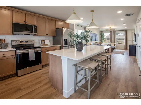 a kitchen with stainless steel appliances kitchen island granite countertop a stove a sink and a microwave