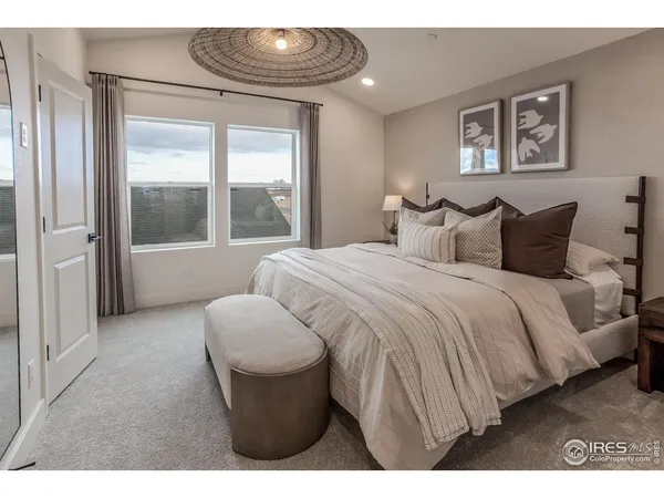 a bedroom with a bed and glass window