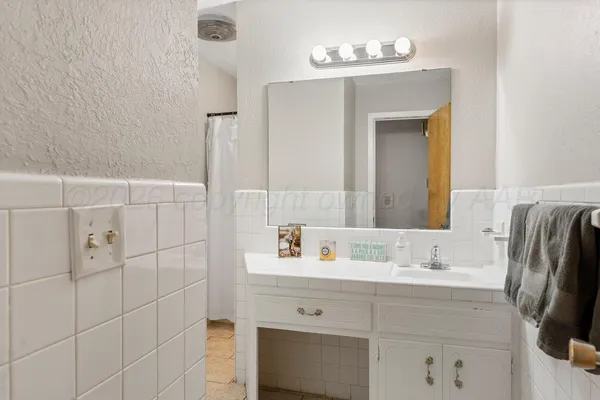 a bathroom with a sink vanity and a mirror