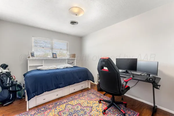 a bedroom with a workspace