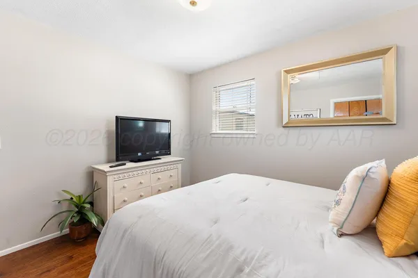 a bedroom with a bed and a flat screen tv