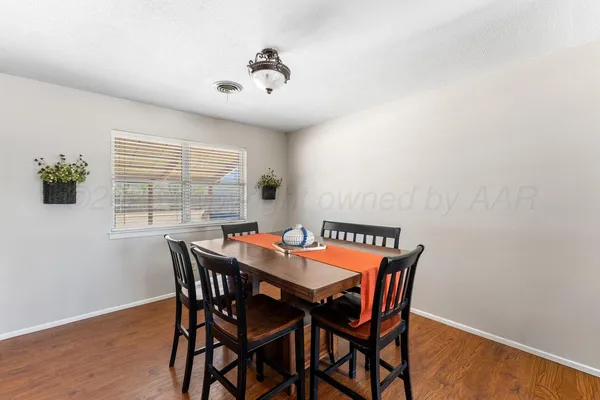 a view of a dining room with furniture and window