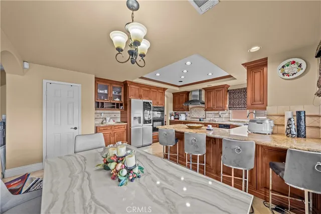 a bedroom with a large bed a flat tv screen and dresser