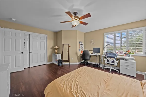 a bedroom with furniture window and flat screen tv