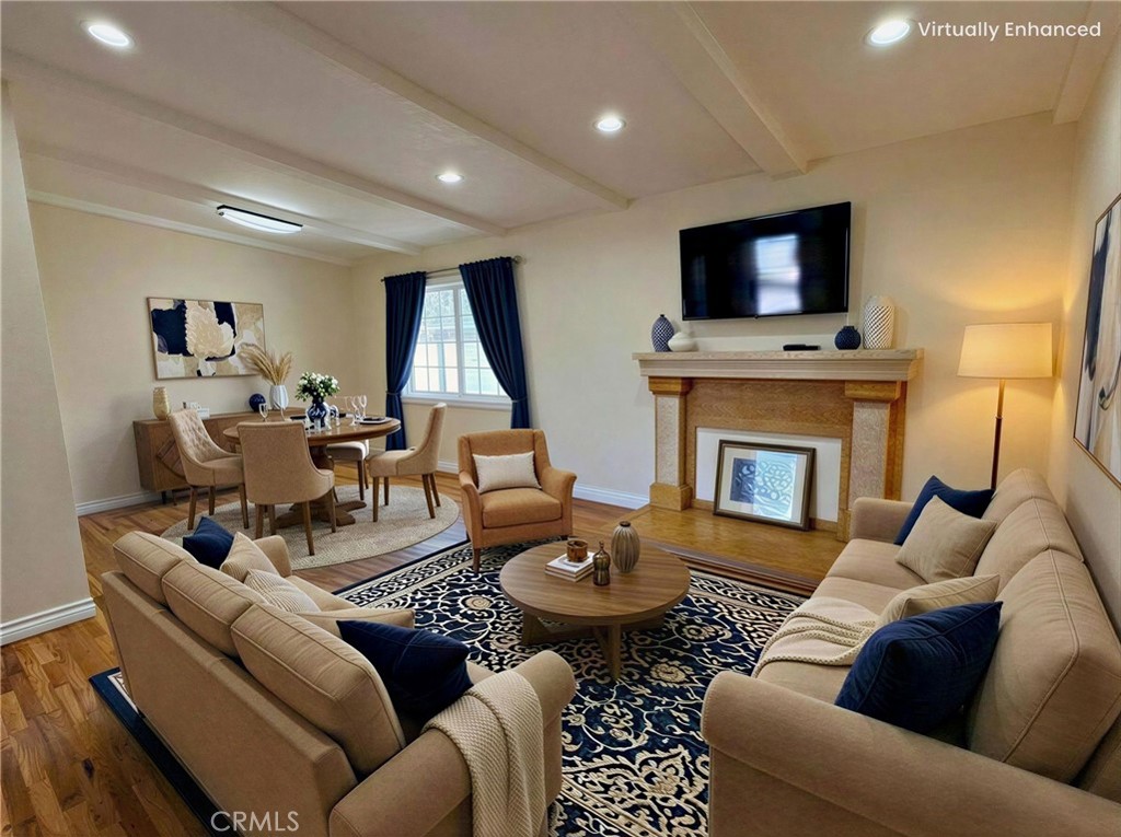 a living room with furniture a flat screen tv and a fireplace