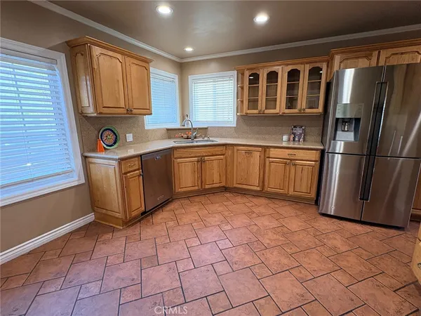 a kitchen with stainless steel appliances granite countertop a refrigerator and a stove top oven