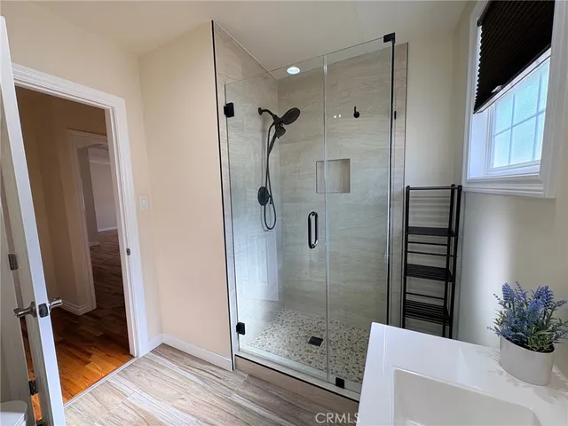a bathroom with a shower and a sink