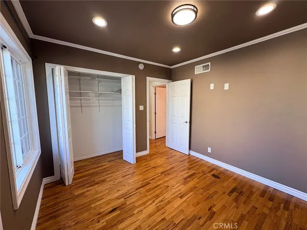 a view of livingroom with an empty space and wooden floor