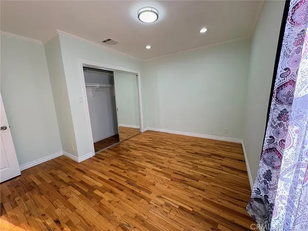 a bedroom with a bed and a mirror