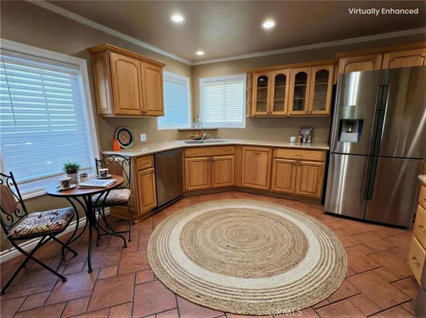 a kitchen with stainless steel appliances granite countertop a sink and a refrigerator