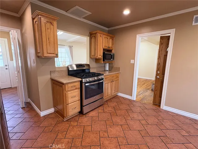 a kitchen with stainless steel appliances granite countertop a stove a sink and a refrigerator