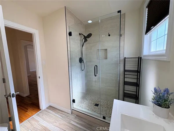 a bathroom with a shower and a sink