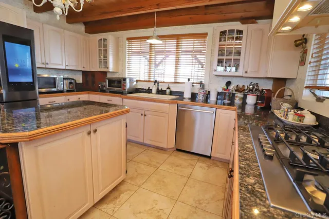 a kitchen with stainless steel appliances granite countertop a sink stove and cabinets